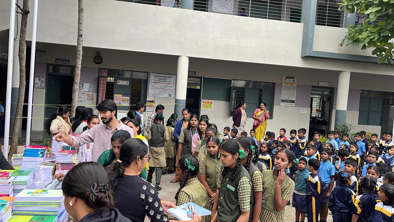 Students lining up for school supply distribution in courtyard