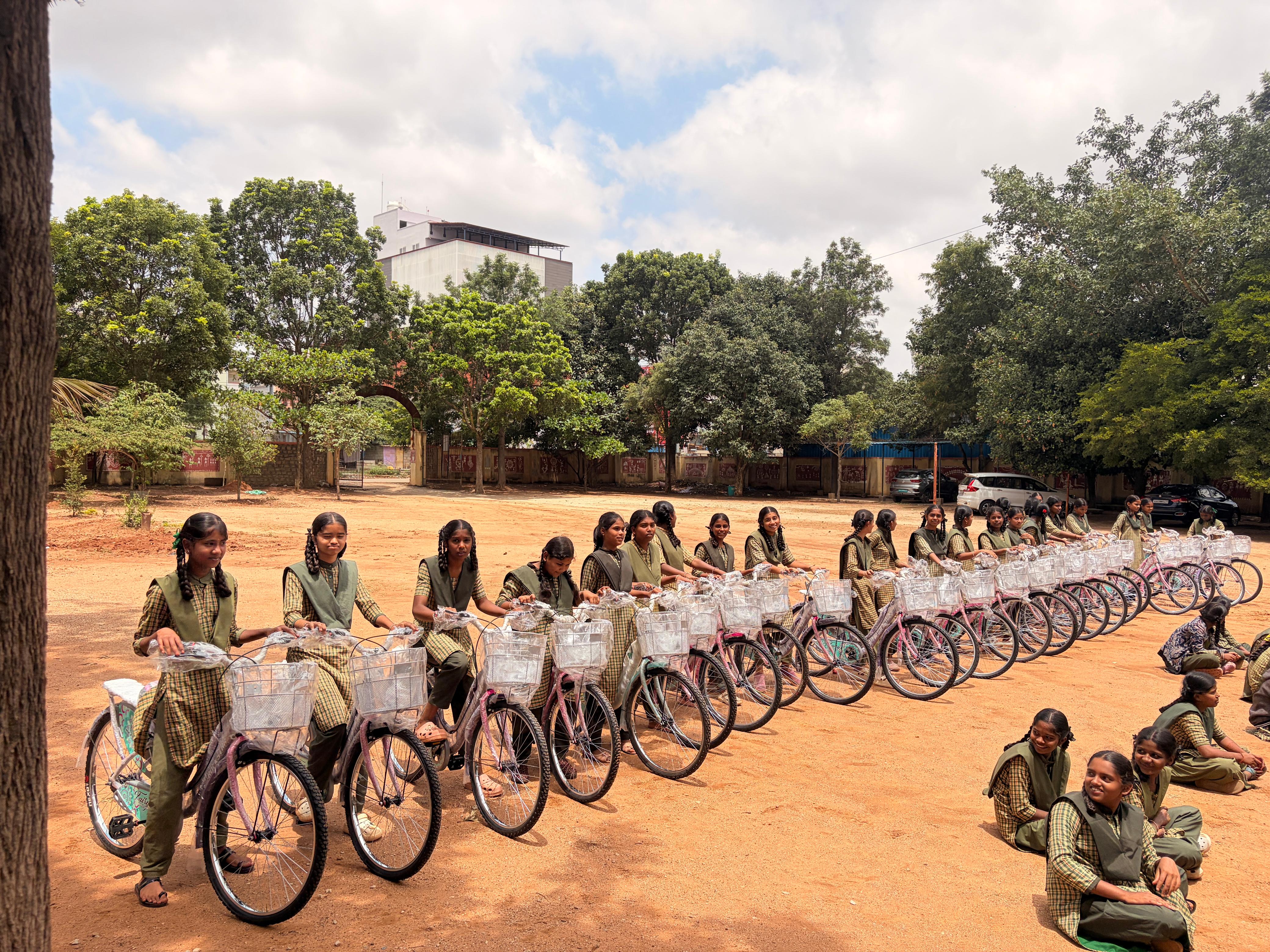 Students lined up with their bicycles in the school ground