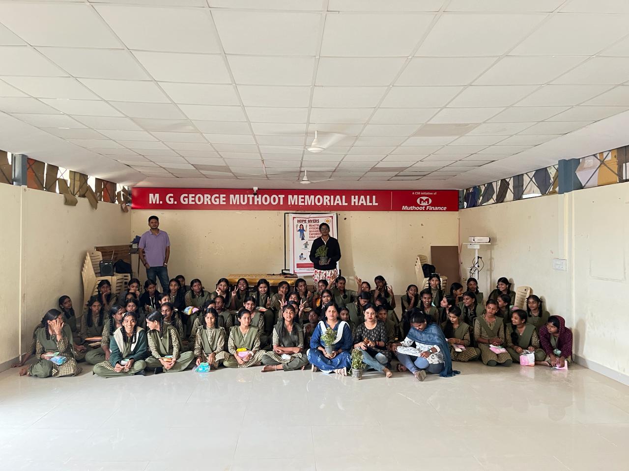 Large group of school students seated for a hygiene workshop