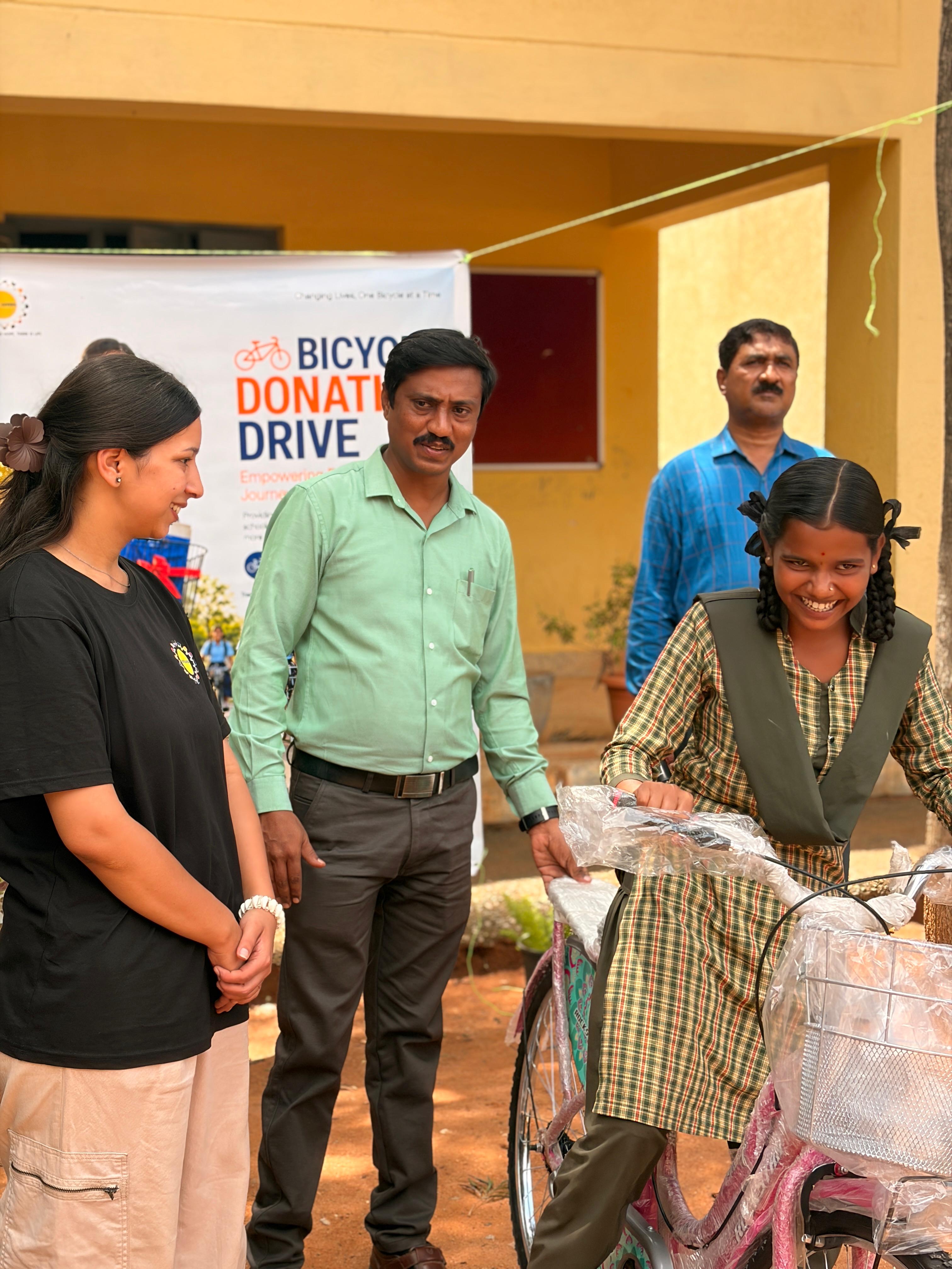 Teachers and volunteers with a student at the bicycle handover