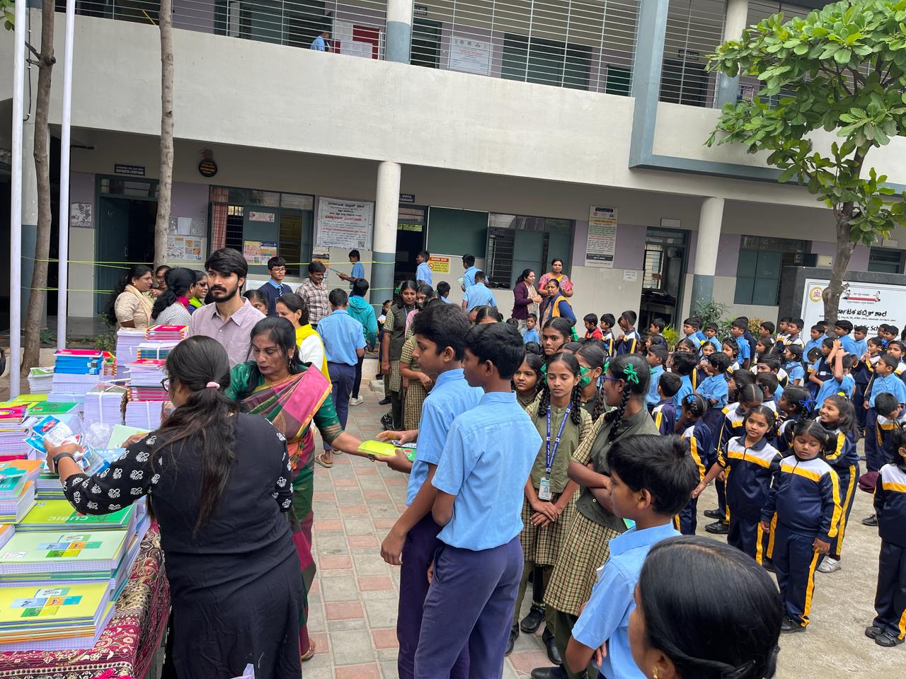 Students lining up for distribution of notebooks and educational materials
